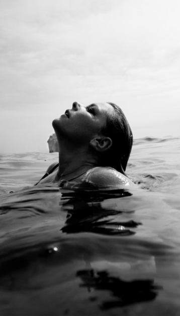 black and white picture of a woman swiming